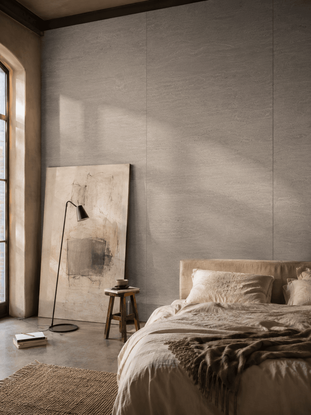 Bedroom at Atelier Gersthofen with stone-look wall panels in the Grigio Alpi decor
